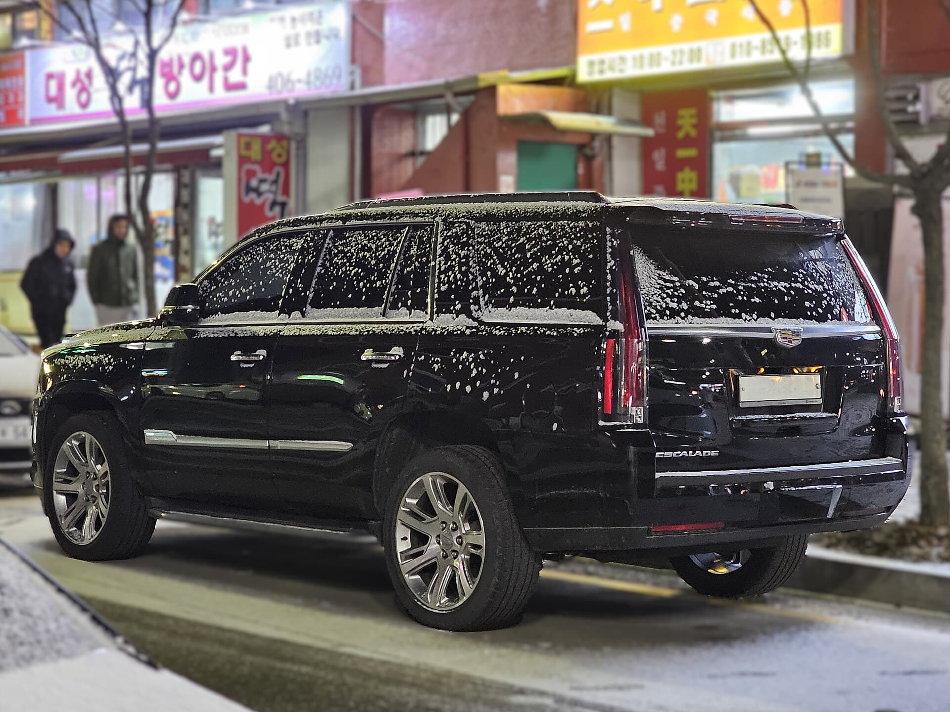 Executive SUV · Escalade at a stone entrance